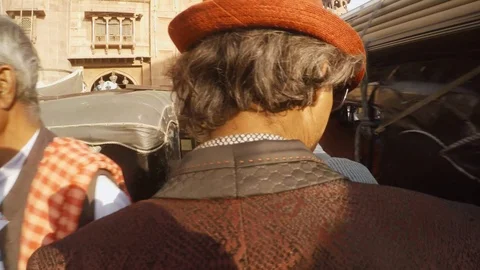 Man in red hat and coat goes through crowd marketplace of Bikaner main gate Stock Footage 90832276