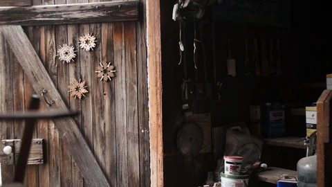 Man with red hat walking into workshop and turning lights on Stock Footage 102045603