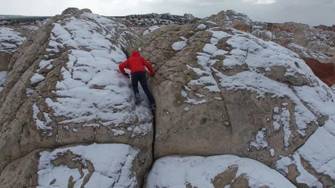 Man Red Jacket Climbs Rock Formation Winter Victory Pose, Arizona Video stock 101625351
