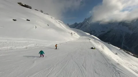 A man in a red jacket goes downhill skiing in the snow in winter Stock Footage 234379945
