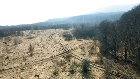 A man in a red jacket hiking the mount. Drone Aerial Stockbeeldmateriaal 151647728