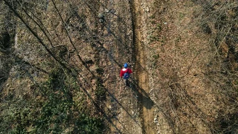 A man in a red jacket hiking the mountain. Drone Aerial Stockbeeldmateriaal 151647660