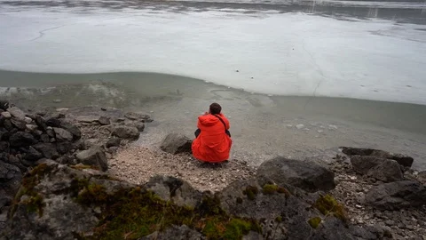 Man in red jacket looking over frozen lake. Stock Footage 125851201