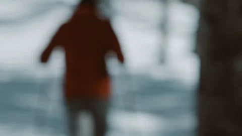 Man with red jacket start to hike in snowy enviroment. Pan shot. Slow motion. Stock Footage 94060458