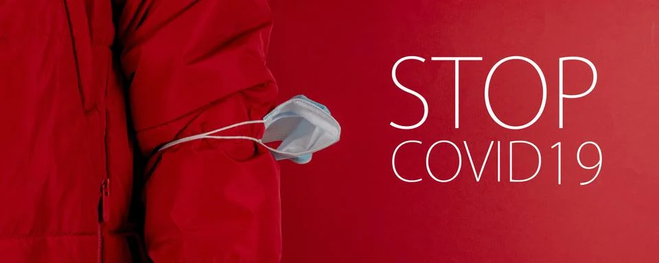 Man in red jacket is using a protective mask against corona virus on red back Stock Photos