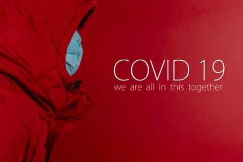 Man in red jacket is using a protective mask against corona virus on red back Stock Photos