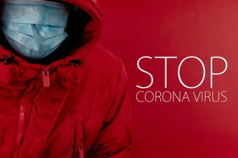 Man in red jacket is using a protective mask against corona virus on red back Stock Photos