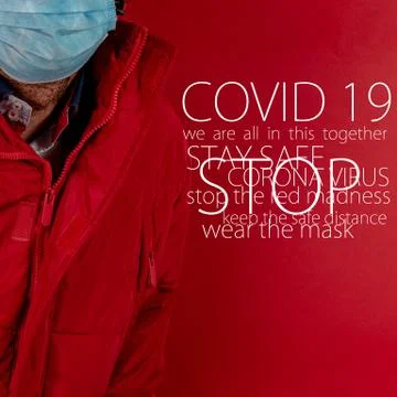 Man in red jacket is using a protective mask against corona virus on red back Stock Photos