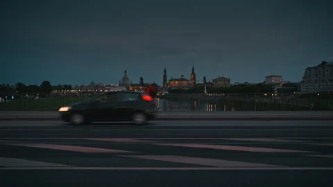 Man in a red jacket walking across a bridge at dusk Stock Footage 315195510