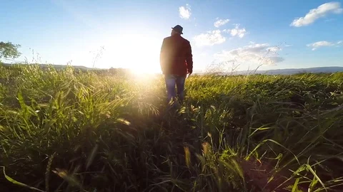 Man with red jacket walks in slow motion , backlight Stock Footage 92499663