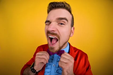 Man in red jacket winks and smile Stock Photos