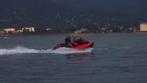 Man on a red jet ski doing tricks Stock Footage 211056557