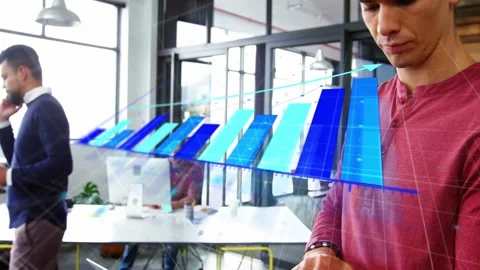Man in red operating laptop and causing animated blue 3D bar graph overlay for Stock Footage 333425693