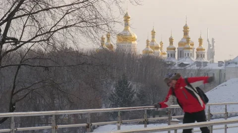 Man in Red Runs And Skating on a Piece of Ice Pedestrian Bridge in Wintery Park Vídeo Stock 59543527
