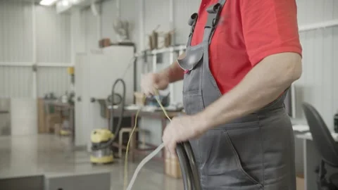 A Man in a Red Shirt Operating a Lathe Machine for Part Production Stock Footage 254972824