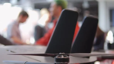 Man in a red shirt is standing behind two black chairs Stock Footage 310712344