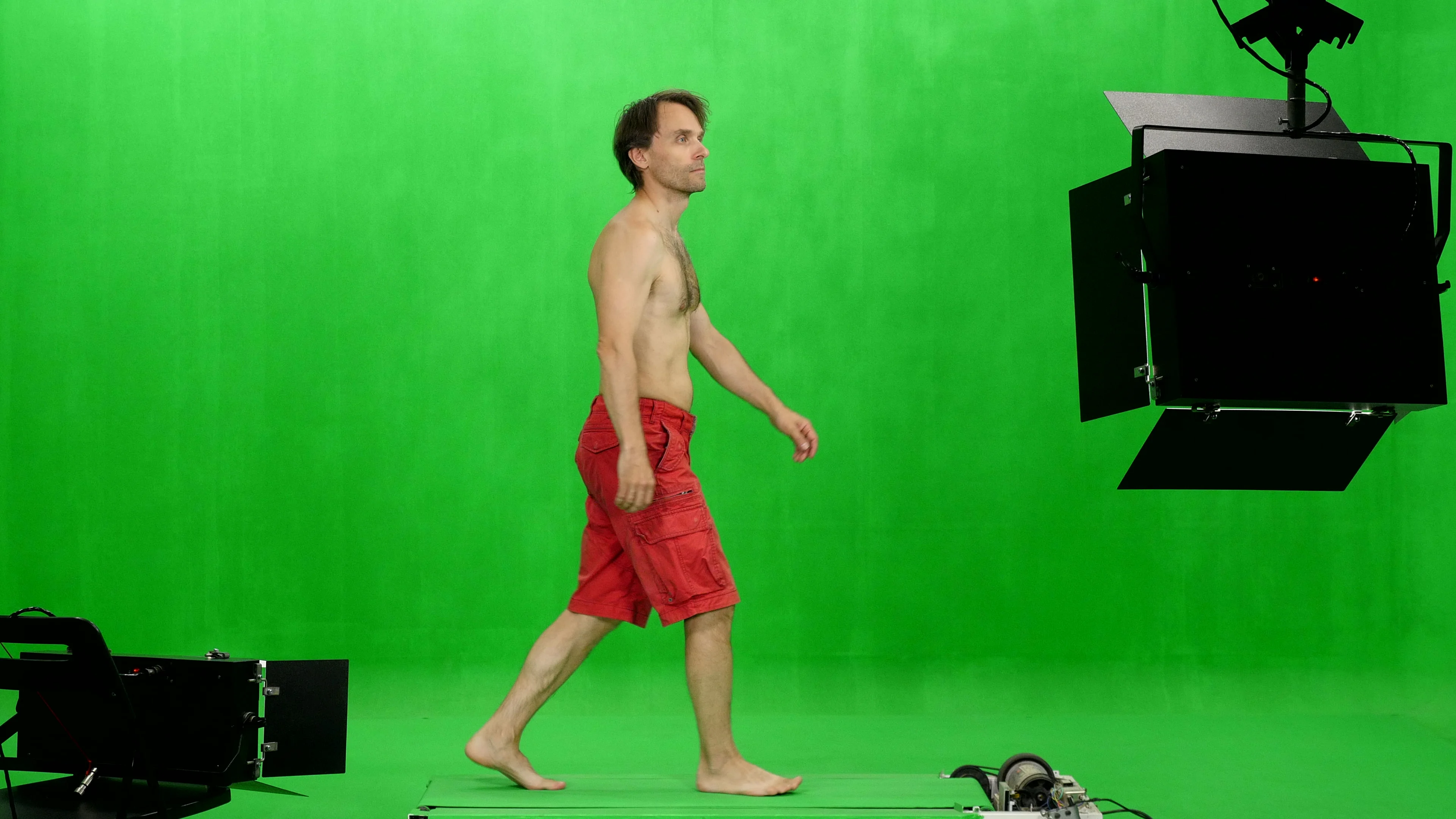 Man in red shorts walking barefoot on a 