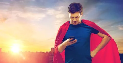 Man in red superhero cape using smartphone Stock Photos