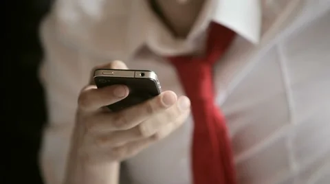 Man with a red tie uses a smartphone Stock Footage 52532973