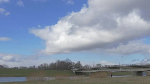 Man in Red is Walking by Dry Field Under Bridge Cars and Lorries Are Driven by Stock Footage 60840964