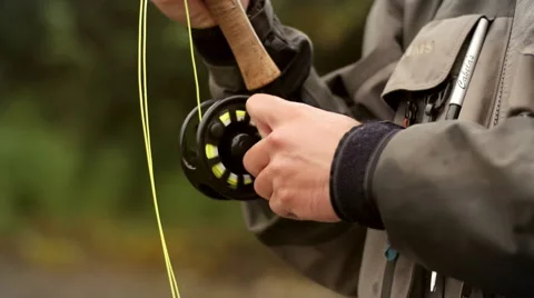 Man Reeling in a Fish from a River Stock Footage 52511147