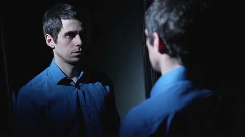 Man reflected in the mirror at dark room Stock-Footage 148336121