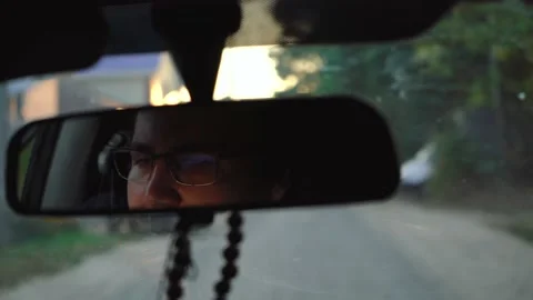 Man is reflected in the rearview mirror Stock Footage 150926217