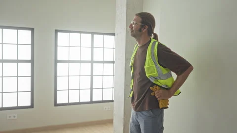 Man in reflective vest with hand on hip holding work gloves, wearing safety.. Stock Footage 337375055