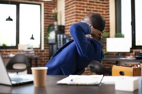 Man reflects on productive work session Stock Photos