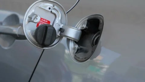 Man refueling car at self service gas station.A Caucasian man, people, busy Видео 336569504