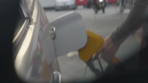 Man refueling car at self service gas station.A Caucasian man, people, busy 库存影片 336569530