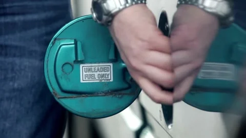 Man refueling car at self service gas station.A Caucasian man, people, busy 스톡 동영상 336569669