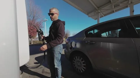 Man refueling his car at a gas station Stock Footage 307045960