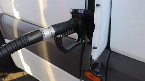 Man refueling transporter bus, putting fuel nozzle into a car tank. Vehicle.. Video stock 283827211