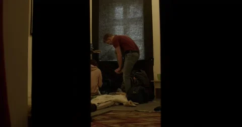 Man refugee puts on white socks spending time in shelter Stock Footage 172027570