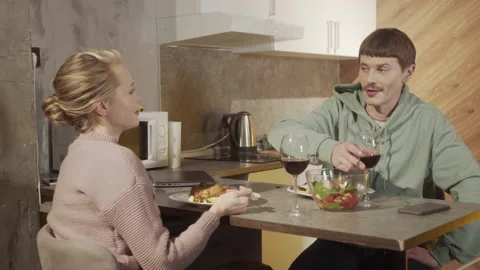 A man refuses to work on a laptop to please his wife, who prepared a festive Stock Footage 145074875