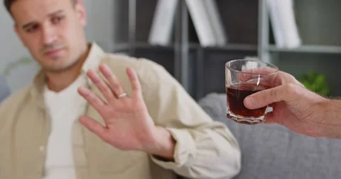 Man Refusing Alcohol Drink with Stop Hand Gesture Promoting Sobriety and Stock Footage 330536098