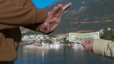 Man refusing and then accepting money near the sea Stock Footage 322806444