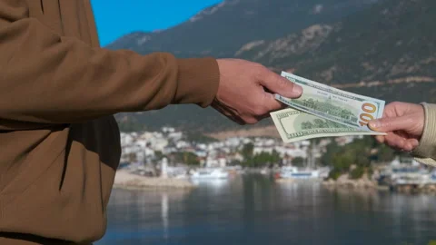 Man refusing bribe money near the sea Stock Footage 318645899