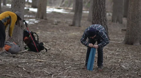 Man refusing help from woman as he tries to set up campsite. Stock Footage 68552502