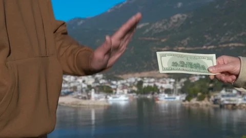 Man refusing money offered by another person Stock Footage 306690241