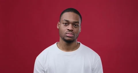 Man regretting wrongdoing over maroon background Stock Footage 147620527