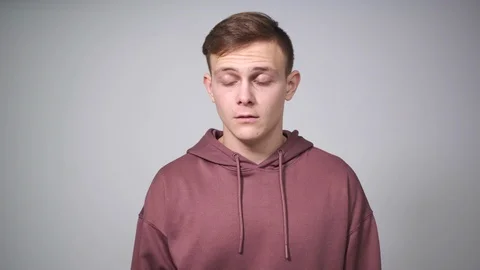 Man regretting wrongdoing over white background Stock Footage 126045422