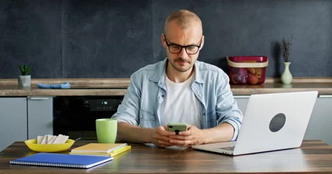 Man rejoices at a message on a smartphone Stock Footage 221444582