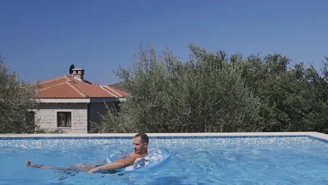 Man relax in swimming pool Stock Footage 137014946