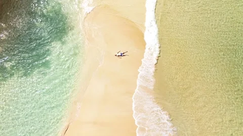 A man relaxes on the beach, view vertically down. Stock Footage 315874767
