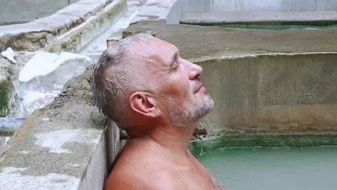 A man relaxes in the pool. Video stock 137555491