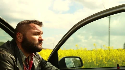 Man relaxes, sitting in car Stock Footage 62861687