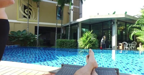 Man relaxes on sunbed on beautiful pool Stock Footage 70967638