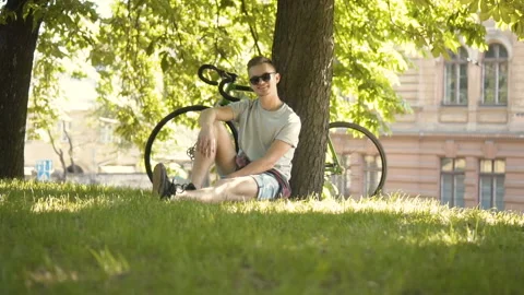 Man Relaxes under Tree Stockbeeldmateriaal 91794627